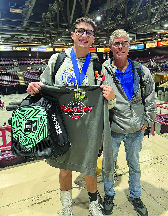 COURTESY PHOTO
Lowry High School's Jhett Harber with head coach John Brooks at the Rollie Lane Invitational in Nampa, Idaho. Harber, who wrestles at 175 pounds, became the first Lowry wrestler since 2012 to win an individual title at the event.