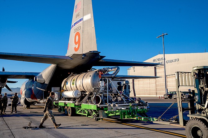 Nevada Air National Guard airmen from the 152nd Maintenance and Logistics Readiness Squadron load the Modular Airborne Firefighting System tank into MAFFS 9 at the Nevada Air National Guard Base on Friday