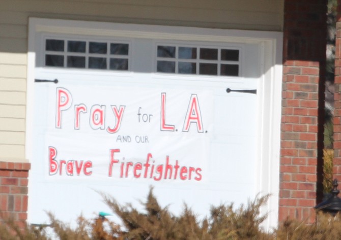 A sign hanging on a garage door north of Genoa on Sunday afternoon.