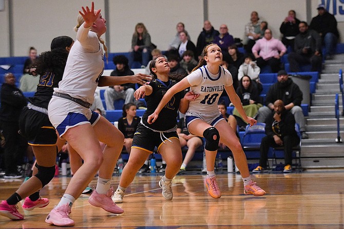 Eatonville's Lillian Bickford (left) and Hailey Hall (right) battle for rebounding position against two Trojan defenders during the Cruisers 55-39 victory over Fife.