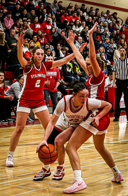 Snohomish Panther junior Sienna Capelli breaks out of a double defense led by Stanwood’s Ellalee Wortham during the Snohomish-Stanwood game Thursday, Jan. 9.
The Panthers took a 62 -49 win over rival Stanwood on Snohomish’s home court.
The Spartans came to play, recovering from a 16 - 3 first quarter to hold on to a 7 point lead at the half, 32 - 25.  The Panthers took control and stretched out to a 62 - 49 final to go into the lead of WESCO 3A North. 
Senior Tyler Gildersleeve-Stiles put in 22 points and made 10 rebounds while Stanwood Spartans junior Ellalee Wortham poured in a 
game-high 24 points and hit 10 - 11 at the free throw line.