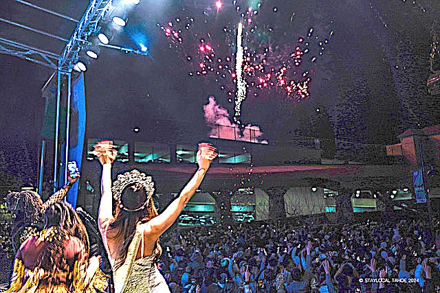 Ms. United World Sophia Nichole cheers for the fireworks at Heavenly Village on New Year's Eve.