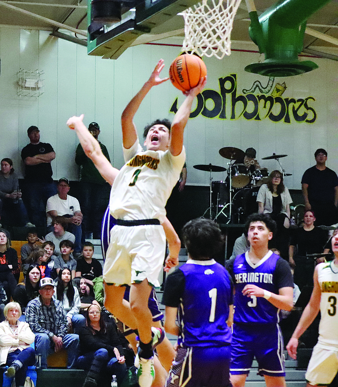 Battle Mountain's Adan Nevarez drives to the basket for two points against Yerington on Saturday..