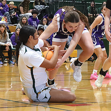 Battle Mountain's Yadira Vazquez fights for control of a loose ball with a Yerington player during Saturday's game in Battle Mountain.