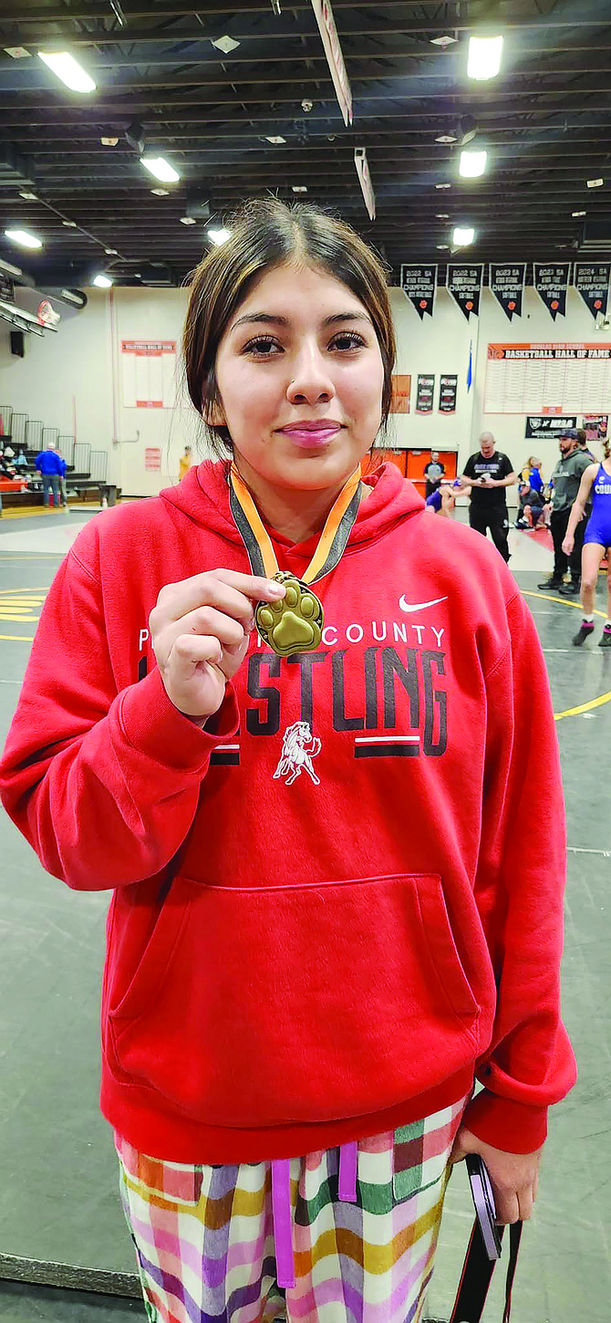 Pershing County's Magdalena Ramirez displays her first-place medal from the Steve Deaton Memorial Tournament at Douglas High School.