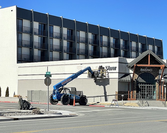 A worker removing the Black Bear Diner sign on the south side of Max Casino in downtown Carson City on Jan. 28.