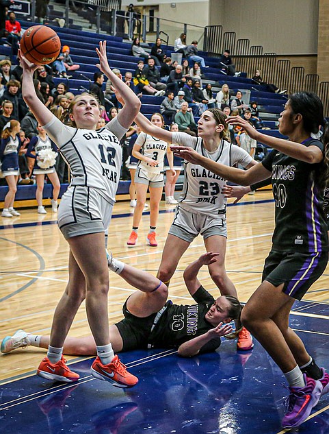 In a rematch that may be a foreshadowing of the Wesco 4A Championship game, the Lake Stevens Vikings slipped by the Glacier Peak Grizzlies 56 - 51 on Friday, Jan. 24 on Glacier Peak’s home court.  
The Grizzlies led at the start of the fourth quarter,, 39 - 35, but the Vikings rallied during the final quarter.  Both teams were dropping 3-point shots and  the Vikings outscored the Grizzlies 21 - 12 in the decisive period.  The Vikings led in turnovers, 17 - 13, but the Grizzlies were more costly. With 3:31 left the score tied at 47 all.  At the 1:32 mark the Vikings edged ahead 53 - 49 on free throws and finished with the victory. 
In the photo, Glacier Peak junior Dylan Gordon aims for two points.