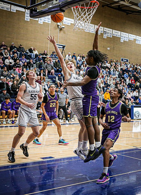 Glacier Peak Grizzly senior Josiah Lee jams the corner on his way to the net in the Grizzlies’ romp over Lake Stevens 64 - 29 on Friday, Jan. 24 on the GP boards.  
After a lackluster first quarter, with Glacier Peak up by 1 at 4 - 5, the game was followed by both teams coming up for air with GP leading at the Half 31 - 13.  Glacier Peak showed strong rebounding at both ends of the courts and good followup scores under their own net.

In Wesco 4A, Glacier Peak currently stood at 8-0 conference, 14-2 overall as of Sunday, Jan. 26. Glacier Peak currenly tops the 4A standings.
Lake Stevens is 3-5 conference, 6-11 overall as of Sunday, Jan. 26.