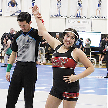 Pershing sophomore Magdalena Ramirez celebrates pinning the Spanish Springs wrestler who defeated her at the regionals last year.