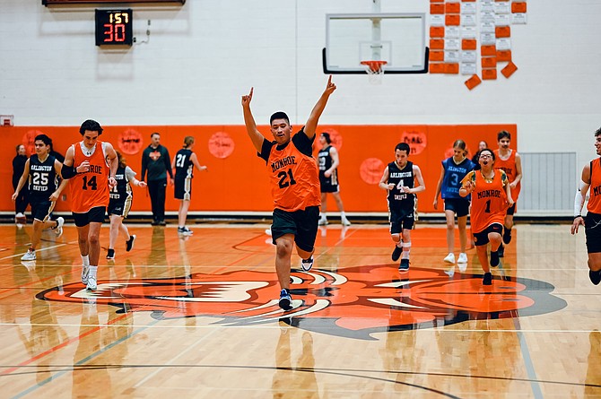 Edgar Hernandez Gaspar (21), with partner Ryan Miller (14) and player Jaylynn Ramos (1), celebrates during the Jan. 8, 2024 game against Arlington.