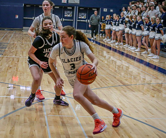 Glacier Peak power player Brynna Pukis drives the corner on the way to 2 of her 24 points. Glacier Peak’s varsity girls played a constantly scoring offense and a dominant defense to rout the Jackson Timberwolves 66 - 33 Friday, Jan. 31 on the home boards. T’Wolves sophomore Makena Devine’s 22 points nearly matched Pukis but the T’Wolves were overwhelmed in every frame. Jackson was behind by 22 at the half.