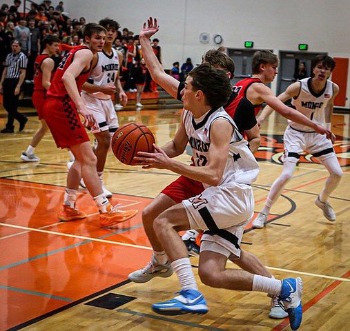 Bearcat sophomore wing Isaiah Kiehl muscles into the paint during the first quarter of the match between Snohomish and Monroe Tuesday, Jan. 28. The Bearcats stayed undefeated in league play edging the Panthers 66 - 59 on the 
Bearcats’ home floor.  The Panthers recovered in the last of the first quarter, trailing 13 - 18 and stood 23 - 31 at the half.  The Panthers rallied in the second half but failed to  capitalize on the shooting possibilities. Snohomish’s 6-foot-2 senior guard Bryson Wheat was the game’s top scorer with 21 points.  Monroe’s effort was led by  junior Chayce Waite-Kellar  with 18 points. Four Bearcats shared the spotlight with 10 points each.