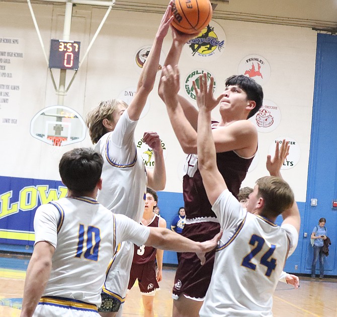 Lowry's Kayd Garner goes up to block a shot against Elko on Saturday.