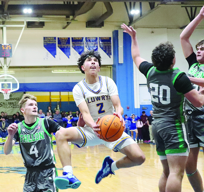 Lowry's Jovanny Cuevas splits the Churchill County defense on his way to the basket in the Buckaroos; overtime win on Friday night in Winnemucca.