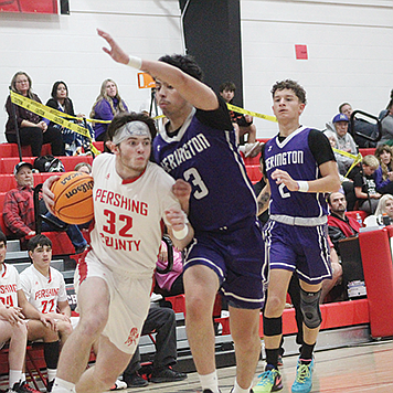 Pershing County's Travis Donaldson drives to the basket in a home game against Yerington.