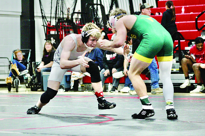 Pershing County’s Israel Knight sizes up his Battle Mountain opponent, Wyatt Madalena, in the 150 -pound first-place match at PCHS last Saturday.