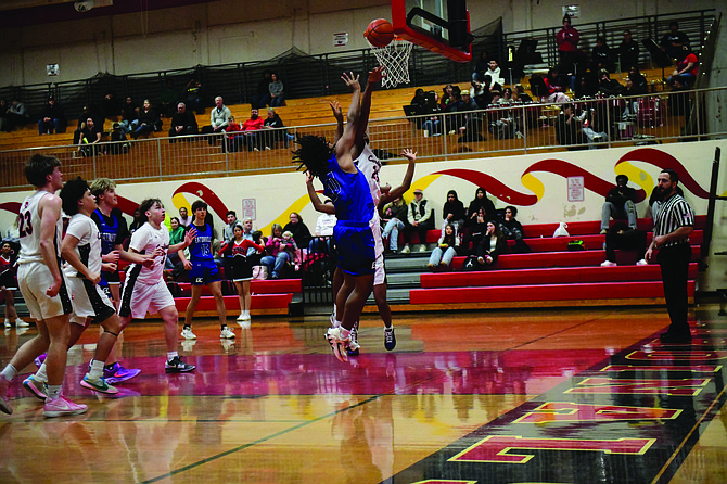 Eatonville's Isaiah Whatley scores two points against a Cardinal defender in the Cruisers loss to Franklin Pierce. Whatley would score a career-high six points in a game earlier in the week against Steilacoom.