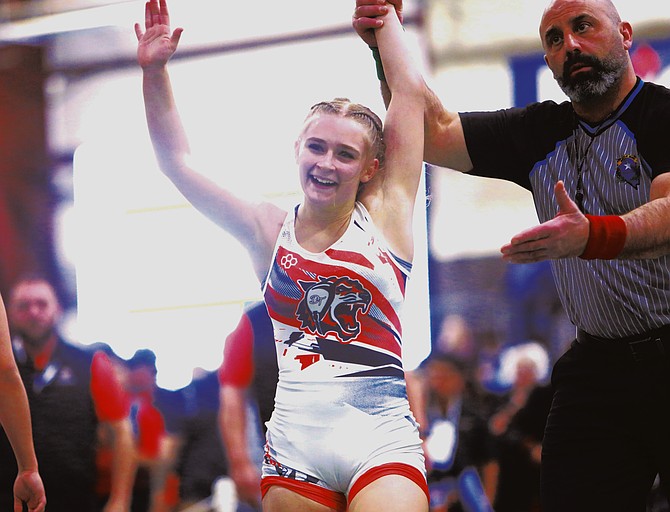 Douglas High School’s Ella Kavanagh gets her hand raised moments after winning the Nevada state title at 105 pounds. Kavanagh won her first state title Saturday in Fallon and took home Douglas’ first state title as a program since 2011.