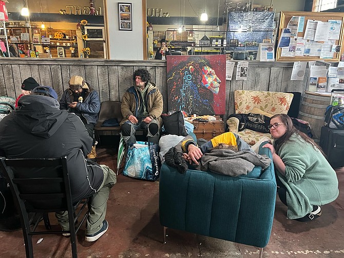 Visitors to Hope ‘N Wellness, a drop-in resource center close to Pacific and Rucker avenues that primarily serves homeless
individuals, take the opportunity to sit on couches and relax in warmth on a recent day. The city says its location is the
problem. It is in a downtown zone that, as currently written, prohibits social services on the first floor.