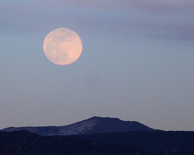 The snow moon rises over the Pine Nuts on Tuesday evening. Whether it is a harbinger of snow forecast to arrive on Thursday remains a question.