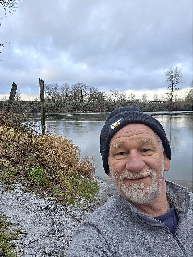 Fred Mydske stands next to the Snohomish River which he frequently swims.