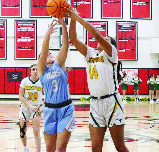 Battle Mountain’s Yadira Vaquez fight for a rebound against Oasis Academy in the opening round of the Northern 2A Regional Tournament in Lovelock on Thursday,