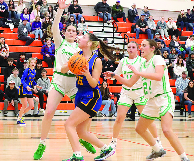 Lowry's Isabel Upton drives through two Churchill County defenders during the semifinal of the Northern 3A Regional Championship on Friday afternoon at Fernley High School.