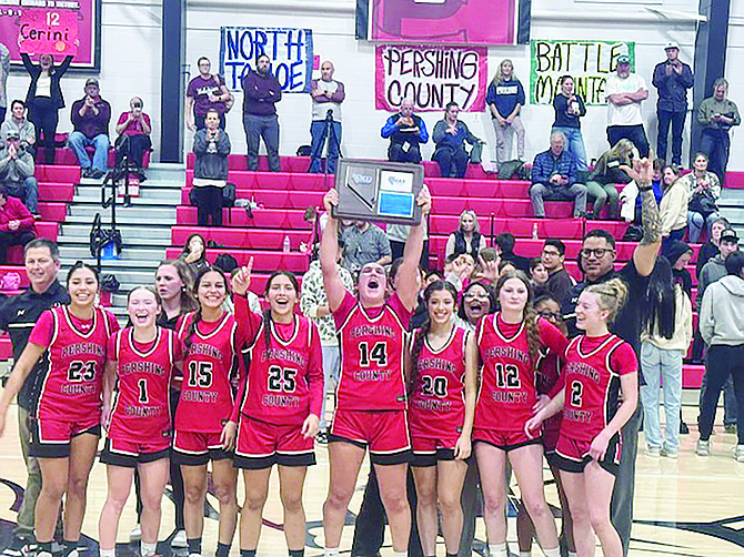 The Pershing County Mustangs display their regional championship trophy after its win over North Tahoe.