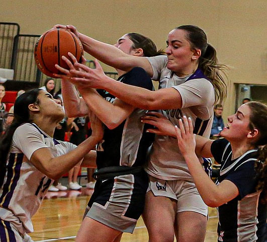 All hands on a rebound during first period play of one of the key matchups for Districts on Saturday, Feb. 22 between the No. 2-ranked Lake Stevens Vikings and No. 5-ranked Glacier Peak Grizzlies.
Trailing 23 - 34 a the half, the Glacier Peak girls roared back in the second half to swamp Lake Stevens 70 - 52 in a solid march to State.  The early Saturday morning game was fast and physical. With both teams slated for State, no one appeared to be concerned about injuries.  The Grizzlies used their signature long passes, strong rebounding and dominate three-point shooting to move up the State bracket.
Glacier Peak opens State play against Emerald Ridge March 1 at the opponents’ court. Lake Stevens will play Issaquah at Issaquah that night.