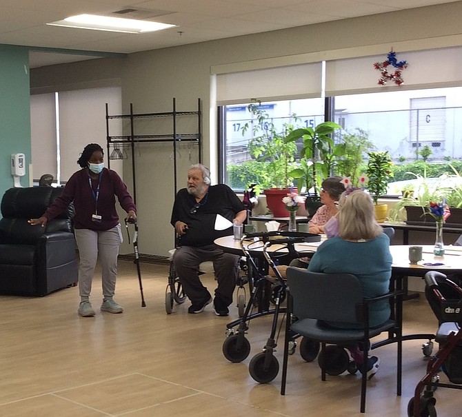 A PACE physical therapist leads a fall prevention 
presentation with group of participants.