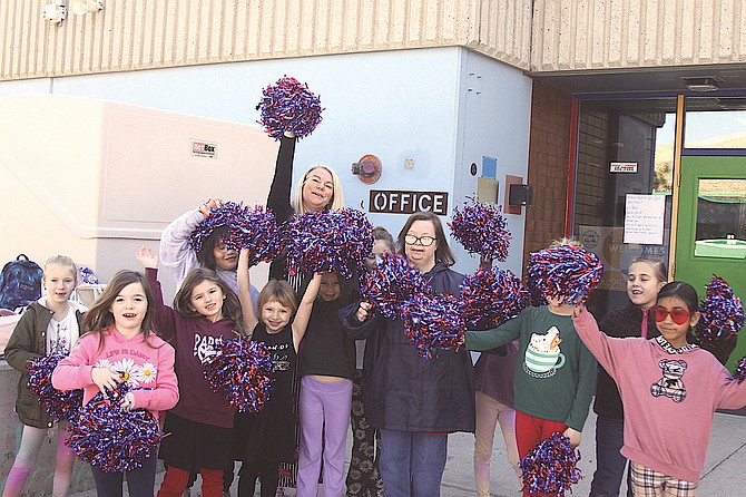 Students and first-grade teacher Jennifer Combs at Jacks Valley Elementary School welcome educators during the Modern Learning Conference school tours on Monday.