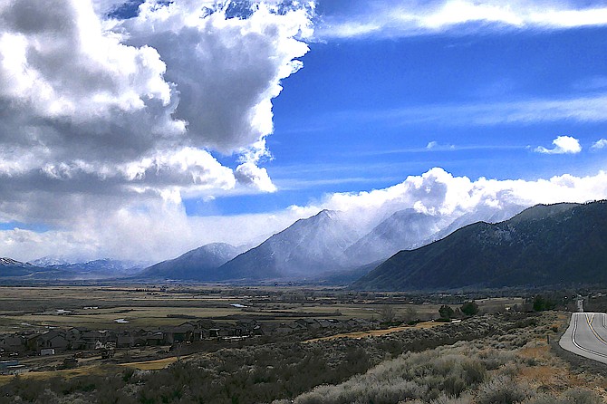 Clouds pour over the Carson Range like a waterfall on Sunday afternoon.