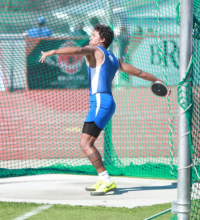 Carson High senior Kekoa Mitchell winds to throw the discus Saturday at Douglas High School. Mitchell won the event with a throw of 126 feet, seven inches.