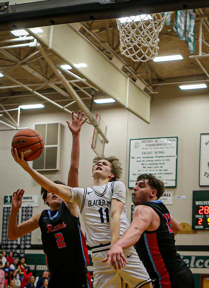 Glacier Peak junior Reed Nagel breaks out for two points during second period action in an opening round match in State playoffs held Friday, Feb. 28 at Jackson High.
On the road to the Tacoma Dome and State the Glacier Peak Grizzlies were tripped up, 55 - 59, by the West Valley Rams of Yakima on Friday evening.
Both teams advance in State. Glacier Peak’s next opponent will be Arlington on March 5 at the Tacoma Dome in a loser-out game. 
The Grizzlies played a balanced, paced game with long passes to move 
the ball under the net, balanced with strong 3-point shooting. GP made goods rebounds with follow-on baskets.
Two hotshots on the Rams, senior Landen Birley and junior Parker Mills, combined to put in 51 points of the Yakima team’s 59.
GP’s Jo Lee scored often and proved  too fast for Rams defenders all night with a team-high 28 points. Senior team mate Jayce Nelson  put in 10 points, nine rebounds and five assists.