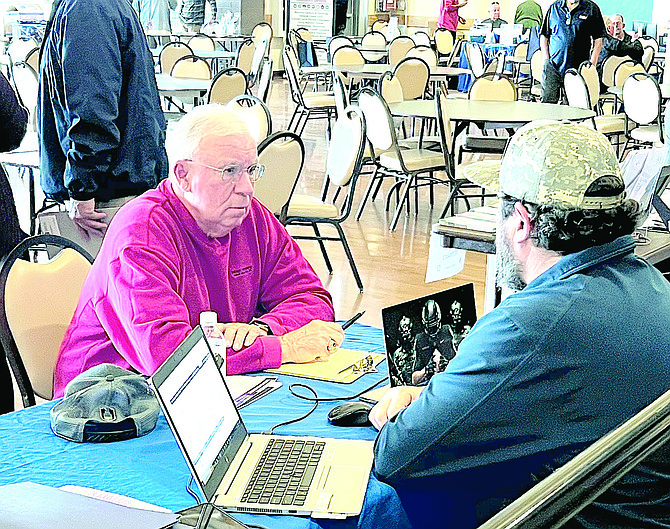 Veteran Dick Schawbe talks to a representative of the Veterans Administration on Feb. 22 in Gardnerville.