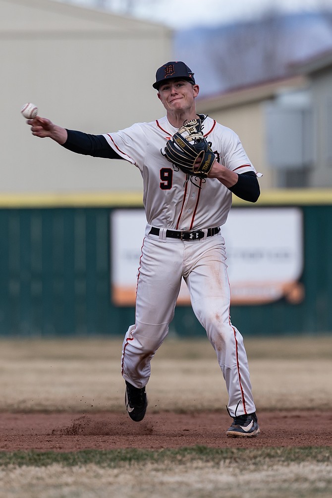 Jackson Ovard makes a throw from across the infield after fielding a ball at third base Tuesday against Fallon. Ovard had the Tigers’ lone multi-hit performance in the 2-0 win.