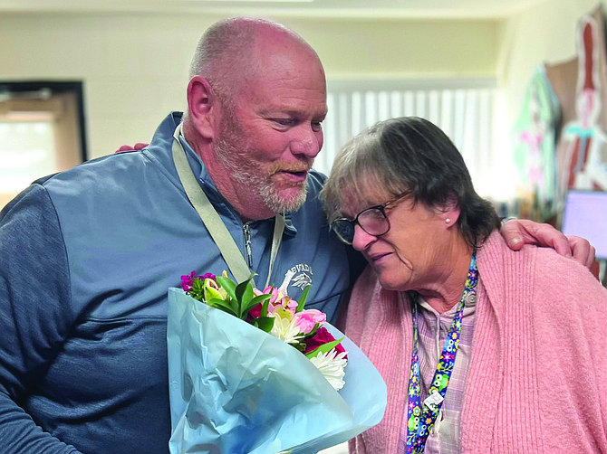 Fritsch Principal Dan Brown congratulates Beverly Singleton on winning the Recognizing Inspirational School Employees (RISE) Award.