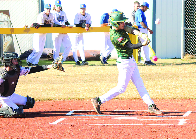 Battle Mountain's Daniel Lara puts the ball in play during a game with the Lowry JV in Winnemucca last week.