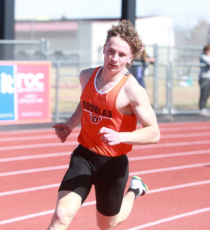 Douglas High’s CJ Bera turns the corner during the 400-meter dash last weekend at the Tigers’ home meet. Bera took third in the 200 this past weekend at McQueen and fourth in the 100.