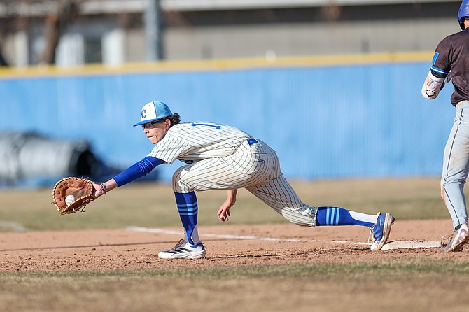 Carson High junior Ethan Cook stretches to make a play at first base against McQueen on Friday. Cook is hitting .385.