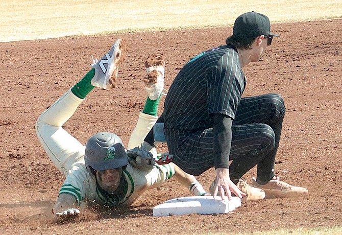 North Valleys' Zach Clarke goes for a backhand tag to try to stop Fallon’s Zack Adams' steal attempt.