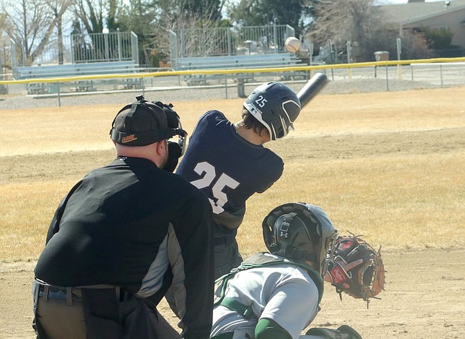 Oasis second baseman Fenn Mackedon (25) swats a base hit against visiting Incline in the first game of a Saturday doubleheader.