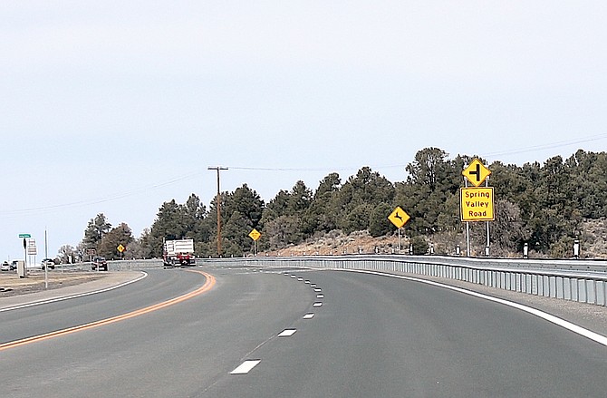 The left turn for Spring Valley Road arrives before the passing lane ends requiring someone to stop in the left lane to turn.