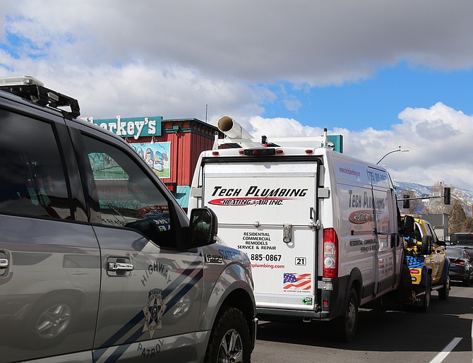 The wreckage of a Tech Plumbing Heating & Air Inc. van was towed through Gardnerville after being involved in a head-on collision on March 8.
