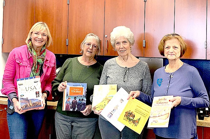Gardnerville Elementary School Principal Marcy Guthrie accepts a book donation from John C. Fremont Chapter Daughters of the American Revolution Linda Jacques, Carolyn Riise and Pamela Ludwig.