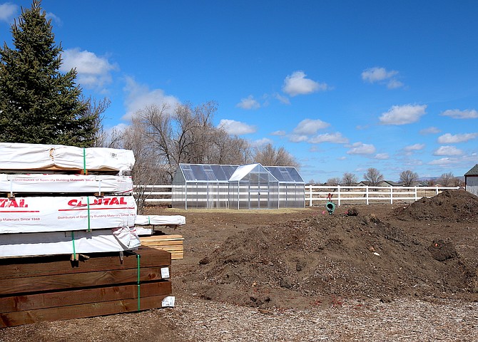 The new greenhouse is up at Heritage Park Gardens as construction materials to build new plant beds await installation.