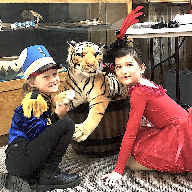 Two Young Chautauqua performers play with the Douglas Tiger at the Carson Valley Museum & Cultural Center in Gardnerville. The group will be performing Saturday.