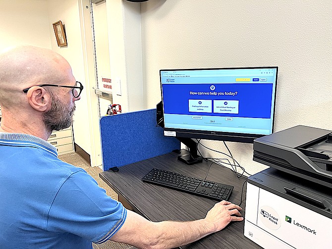Douglas County Library Director Tim DeGhelder demonstrates the use of a legal kiosk at the Minden Branch.