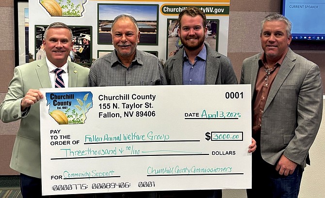 Charlie Arciniega accepts $3,000 in funding on behalf of Fallon Animal Welfare Group. From left: Commissioner Eric Blakey, Arciniega and Commissioners Myles Getto and Matt Hyde.