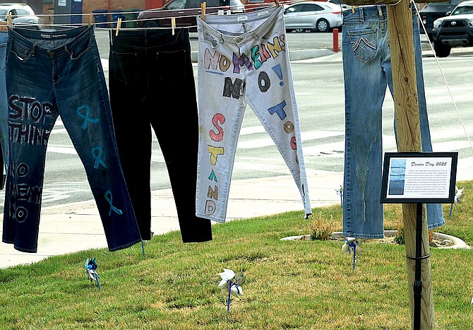 A clothesline of denim items is displayed in recognition of Denim Day. The first Denim Day occurred in 1999 in Los Angeles.